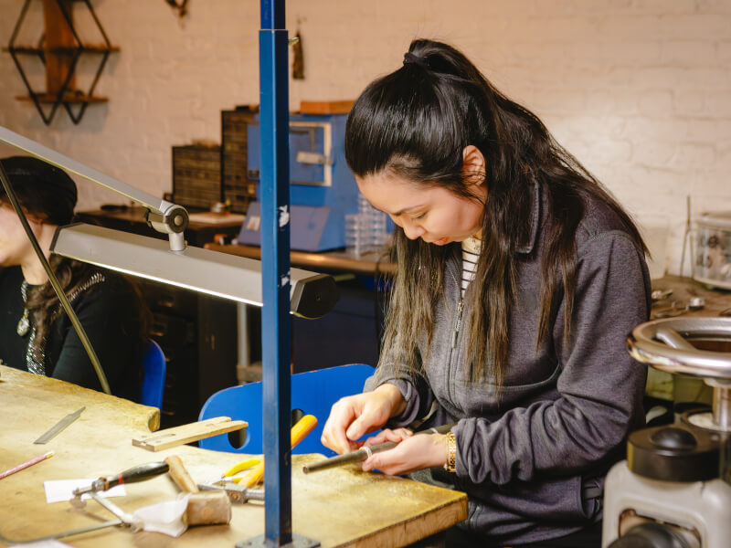 Woman measuring ring in a jewellery class